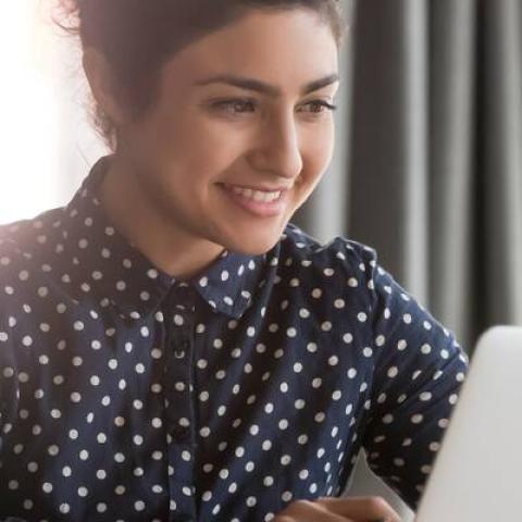 Smiling student on a laptop